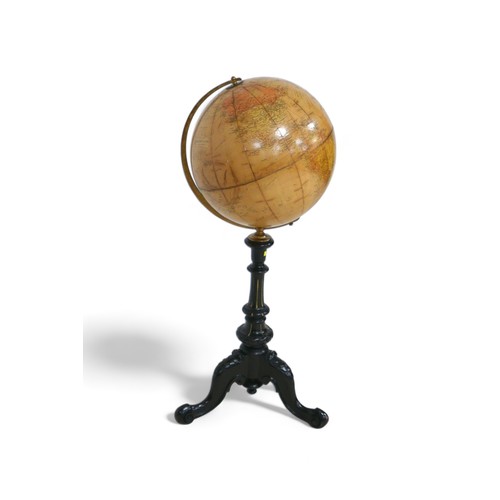 635 - A Phillips 12 inch terrestrial library globe on an ebonies tripod stand, 34 by 90 cm tall.