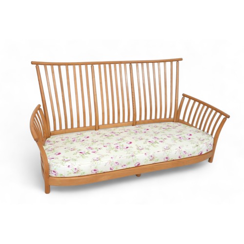 632 - An Ercol three piece slat back blonde elm lounge suite, comprising a three seater sofa, model 1068, ... 