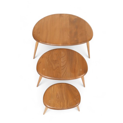 625 - A nest of three Ercol blonde elm pebble side tables, model 354, largest table 66 by 45 by 40.5cm hig... 