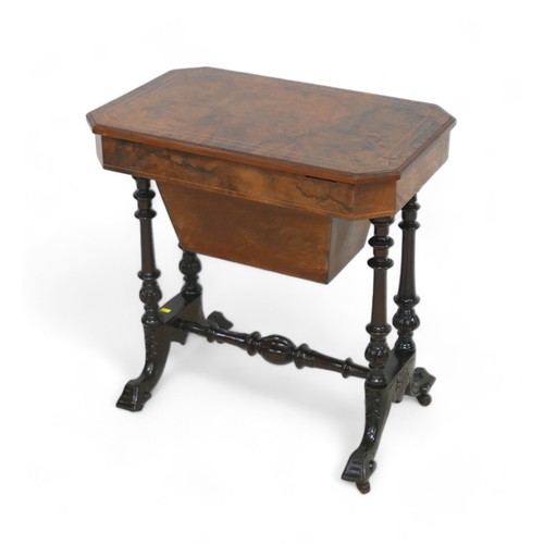 622 - A Victorian burr walnut workbox with a fitted interior on turned pillar supports united by a streche... 