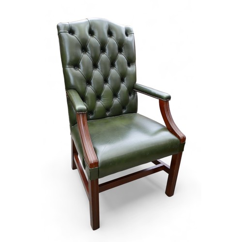 614 - A modern green leather button back library open armchair, 61 by 60 by 108cm.