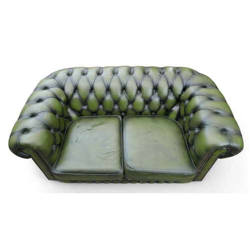 621 - A modern green leather button back Chesterfield sofa, 153cm by 87cm by 72cm tall.