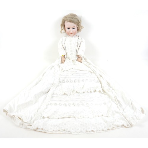 190 - An Armand Marseille bisque porcelain headed doll with open mouth and sleepy eyes, 80cm tall.