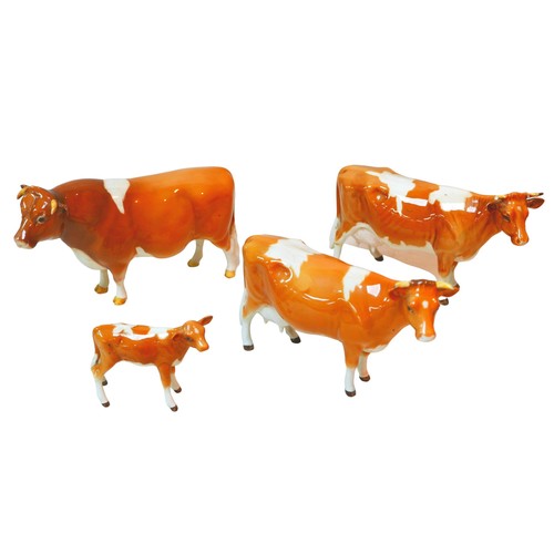 82 - Four Beswick figurines modelled as Guernsey cows, one a/f. (4)