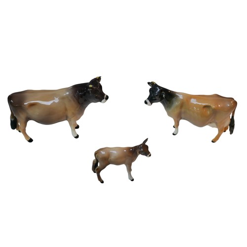 86 - Three Beswick figurines of Jersey cattle, comprising bull 'Dunsley Coy Boy', 11cm high, a cow 'Newto... 