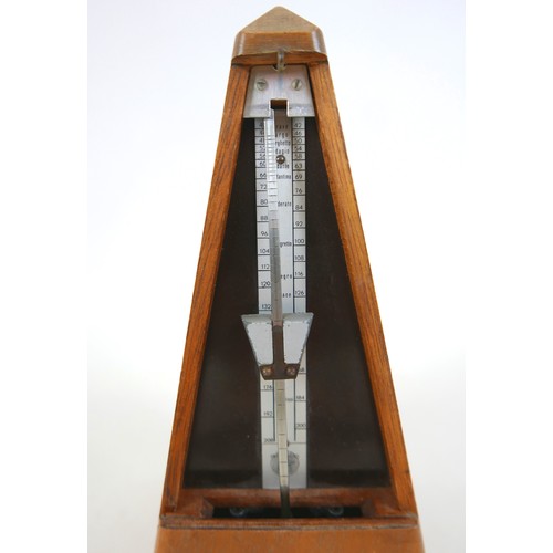 149 - A French metronome by Paquet, 11cm by 11cm by 22cm tall.