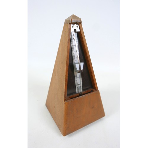 149 - A French metronome by Paquet, 11cm by 11cm by 22cm tall.