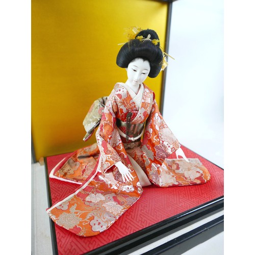 187 - A Japanese Geisha girl doll in display case, 41 by 36 by 44cm high.