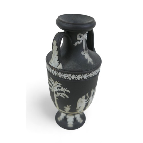 71 - A small Wedgwood black jasper ware twin handle vase 6cm diameter by 13cm tall.