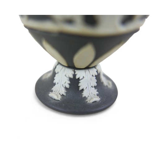 71 - A small Wedgwood black jasper ware twin handle vase 6cm diameter by 13cm tall.