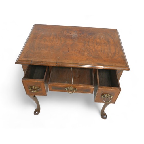 628 - A walnut lowboy, with three small drawers and cabriole legs, 73 by 47 by 73cm high.