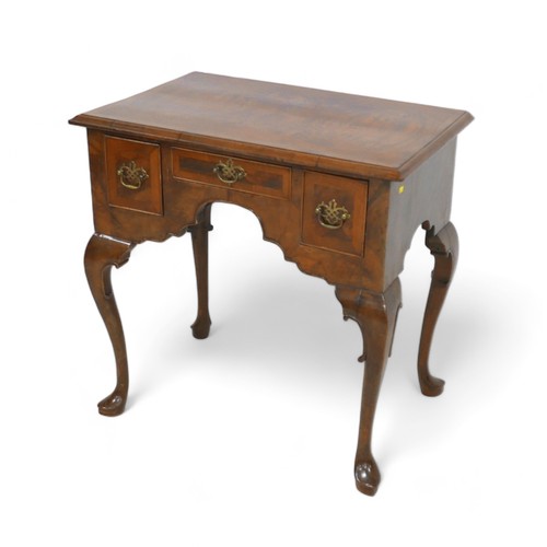 628 - A walnut lowboy, with three small drawers and cabriole legs, 73 by 47 by 73cm high.