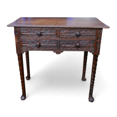 601 - An 18th century oak lowboy, with later carved decoration, two over one drawers.