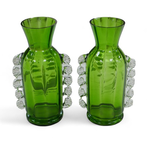 61 - A pair of Victorian green glass vases, in Mary Gregory style, decorated with Lily of the Valley. (2)