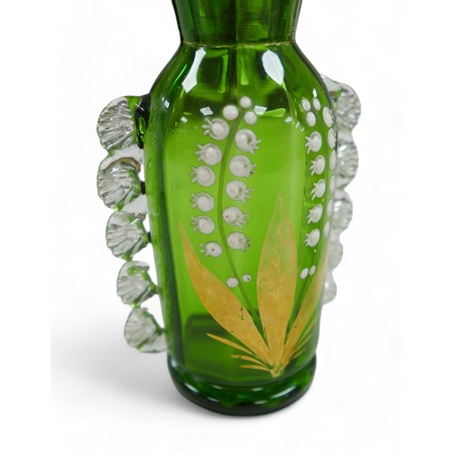 61 - A pair of Victorian green glass vases, in Mary Gregory style, decorated with Lily of the Valley. (2)