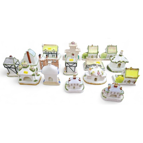 80 - A group of sixteen Coalport bone china ornaments, each modelled as a house, including 'The Watermill... 