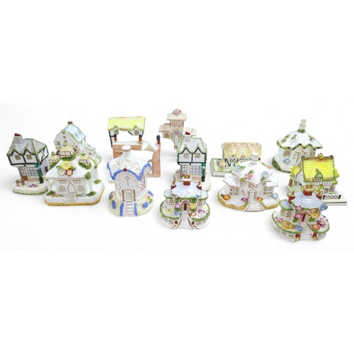 80 - A group of sixteen Coalport bone china ornaments, each modelled as a house, including 'The Watermill... 