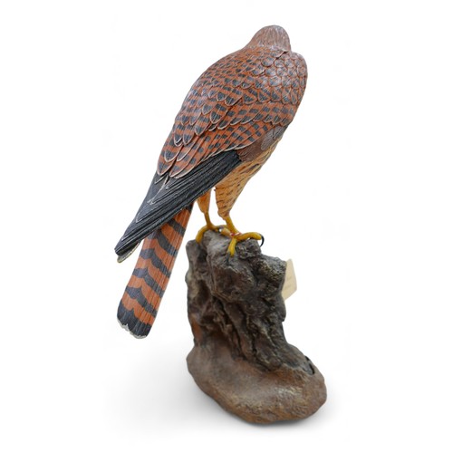 128 - A group of three resin sculptures, including 'Kestrel' by John Moore, JM 194 L, a Border Fine Arts p... 