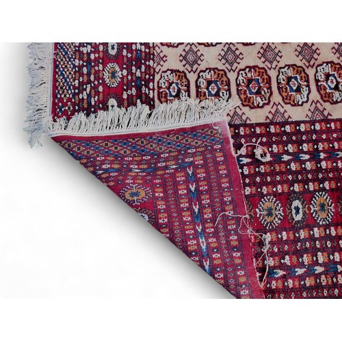 630 - A large Tekke carpet, with eight rows of twenty-eight guls on a cream ground, with multiple red colo... 