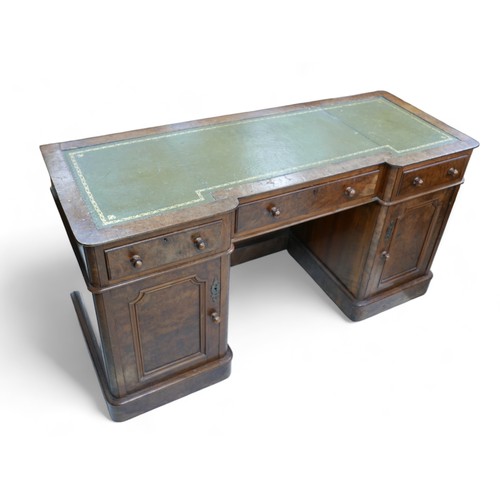 657 - A late Victorian walnut veneered desk, green leather surface, three frieze drawers with turned knobs... 