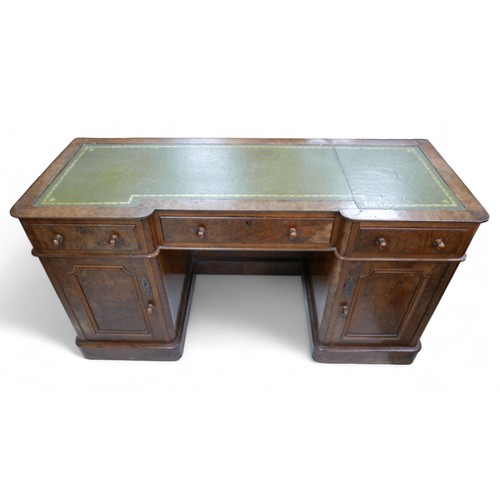 657 - A late Victorian walnut veneered desk, green leather surface, three frieze drawers with turned knobs... 