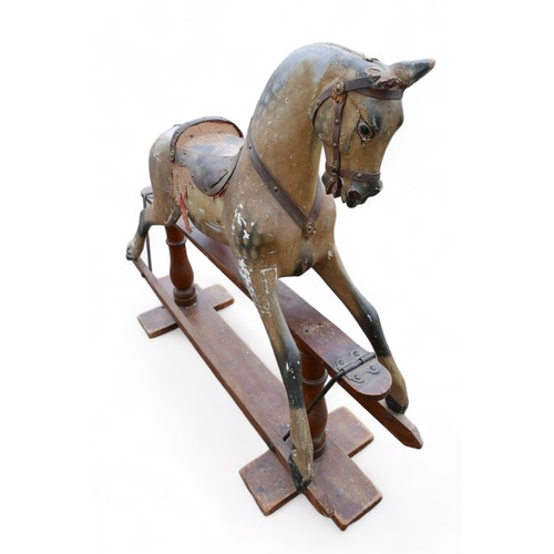 140 - An Edwardian rocking horse, dapple grey with part leather saddle and red cloth sides, a/f missing sa... 