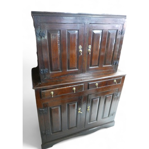 631 - A 17th century oak cupboard, with two doors, two drawers, and two cupboards below, in two sections, ... 