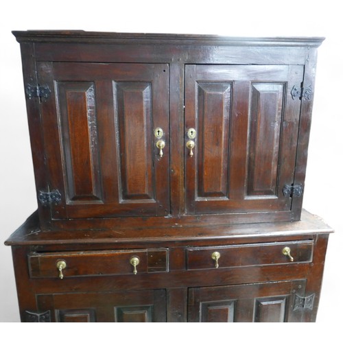 631 - A 17th century oak cupboard, with two doors, two drawers, and two cupboards below, in two sections, ... 