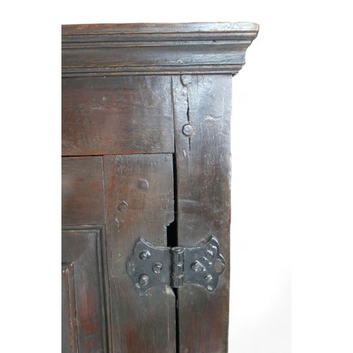 631 - A 17th century oak cupboard, with two doors, two drawers, and two cupboards below, in two sections, ... 