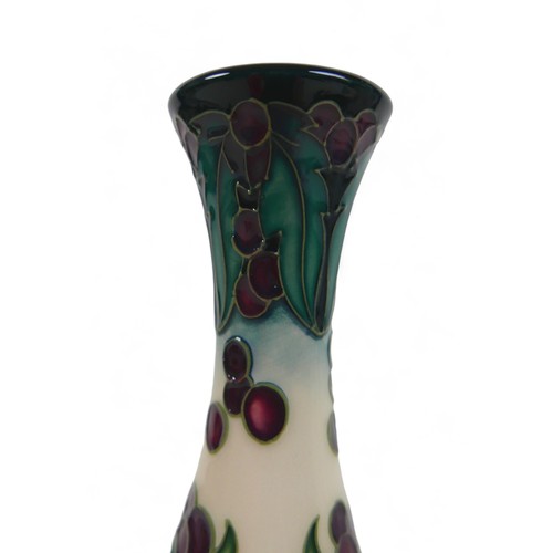 29 - A Moorcroft tall neck vase, decorated with red flower and stylized green and white leaf details, mar... 