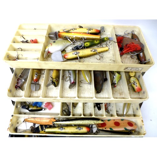 175 - A collection of spoon and bait fishing lures contained in a folding case, including Shakespeare, app... 