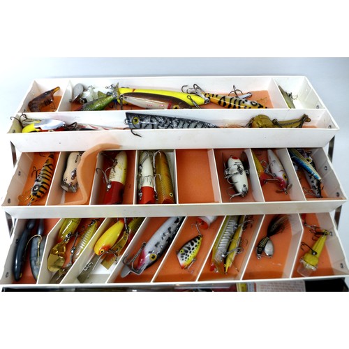 181 - A collection of spoon and bait fishing lures, mainly by Heddon, approximately 90 in total, contained... 