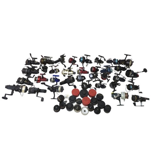 183 - A collection of thirty three spool fishing reels including Shimano Triton Baitrunner, Cardinal 664GT... 