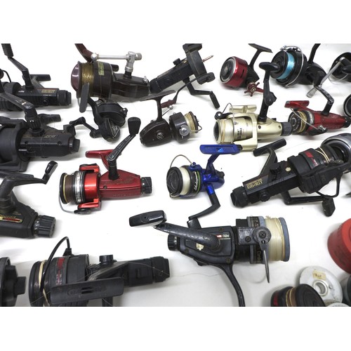 183 - A collection of thirty three spool fishing reels including Shimano Triton Baitrunner, Cardinal 664GT... 