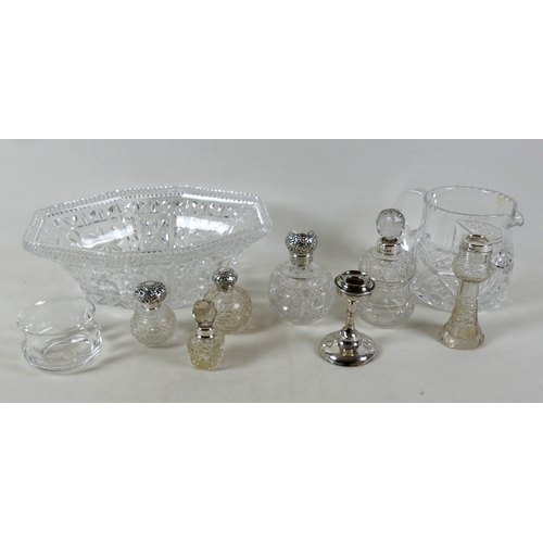 110A - A group of silver topped cut glass bottles, three ovoid with silver tops, two and a vase with silver... 