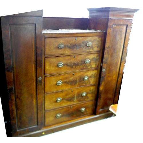 606 - A Victorian mahogany compactum wardrobe, chest centre with five long drawers, flanked by a pair of n... 