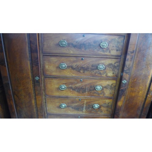 606 - A Victorian mahogany compactum wardrobe, chest centre with five long drawers, flanked by a pair of n... 