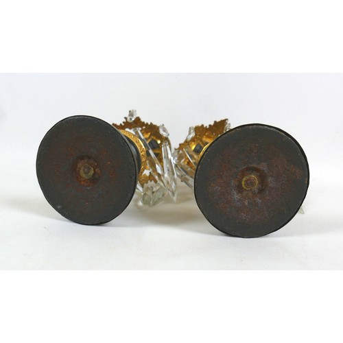 131A - A pair of 19th century bronze and gilt metal candlesticks, removable drip trays above a collar of ei... 