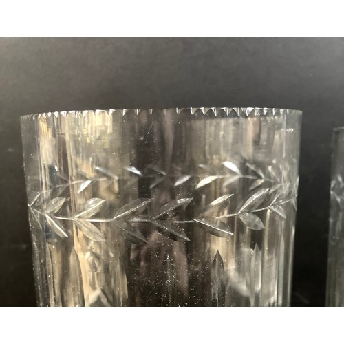 108 - A pair of Victorian tall, clear glass vases, wheel engraved with leaf rim, raised on a column and sq... 