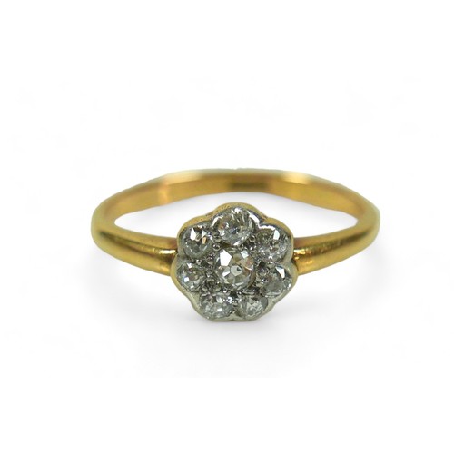 148 - An 18ct gold and diamond flower head ring, size M/N, 2.3g.