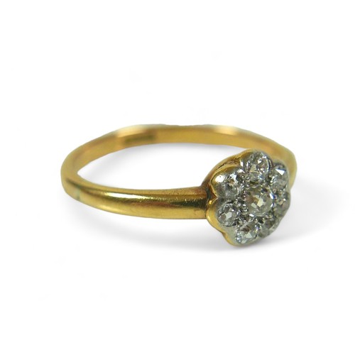 148 - An 18ct gold and diamond flower head ring, size M/N, 2.3g.