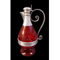A Victorian silver-mounted cranberry glass jug for claret / ecclesiastical use with Maltese cross th... 