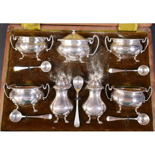 66 - An Edwardian silver seven piece cruet set, pepper 8.7cm high, with five spoons, Henry Matthews, Birm... 