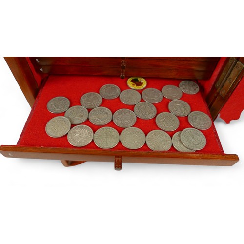 84 - A collection of mainly English coins and other items contained in a nine drawer mahogany collectors ... 