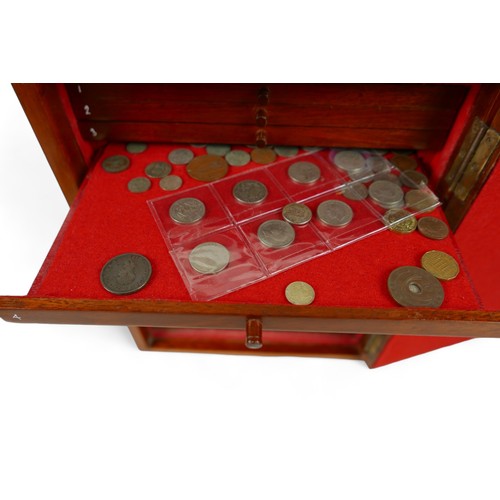 84 - A collection of mainly English coins and other items contained in a nine drawer mahogany collectors ... 