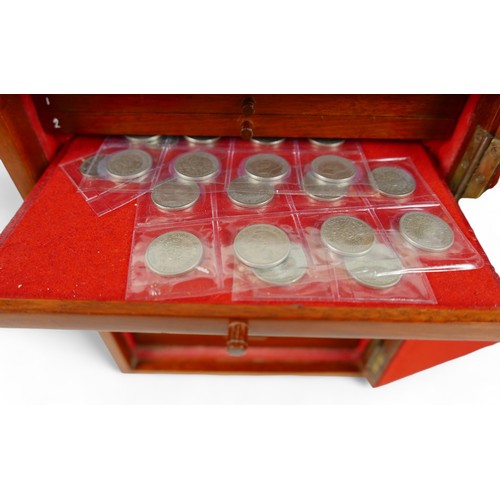 84 - A collection of mainly English coins and other items contained in a nine drawer mahogany collectors ... 