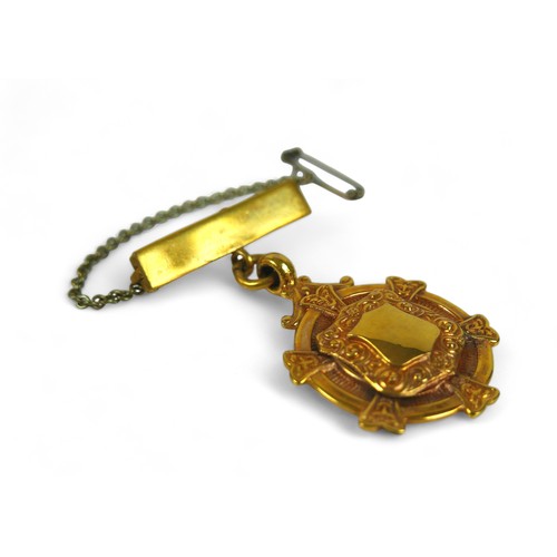 131 - A 9ct gold presentation medal, on yellow metal pin with safety chain, gross weight 7.4g.