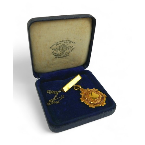 131 - A 9ct gold presentation medal, on yellow metal pin with safety chain, gross weight 7.4g.