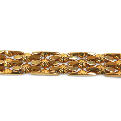 228 - An 18ct yellow gold bracelet, with oval lozenge and flowerhead detailing, 1.0 by 19.0cm, 20.8g, in g... 