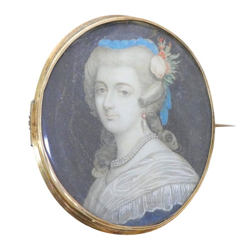 130 - A 19th century portrait miniature of a lady, hand painted on ivory, depicted with flowers in her hai... 